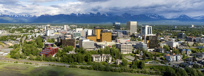 An aerial view of Anchorage with the Chugach Mountains beyond.  – Wayde Carroll / Visit Anchorage